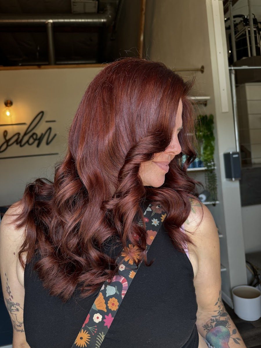 Long red-copper color styled in loose, bouncy curls